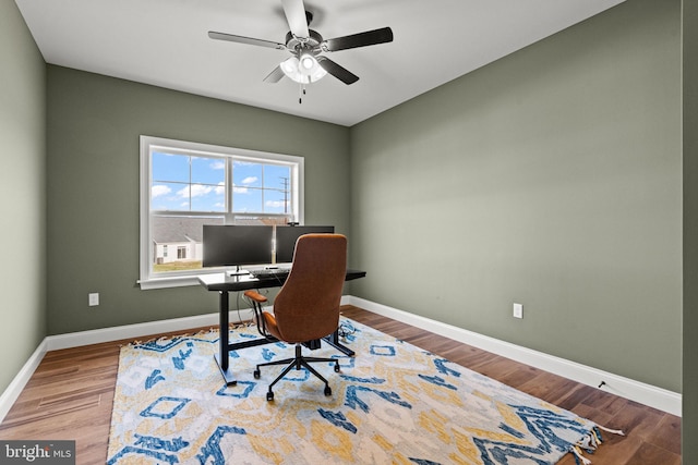 home office featuring hardwood / wood-style flooring and ceiling fan