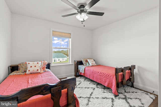 bedroom with hardwood / wood-style floors and ceiling fan