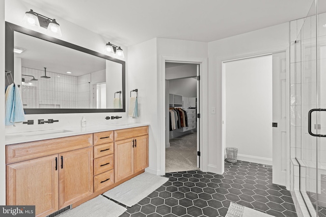 bathroom featuring vanity, walk in shower, and tile patterned flooring