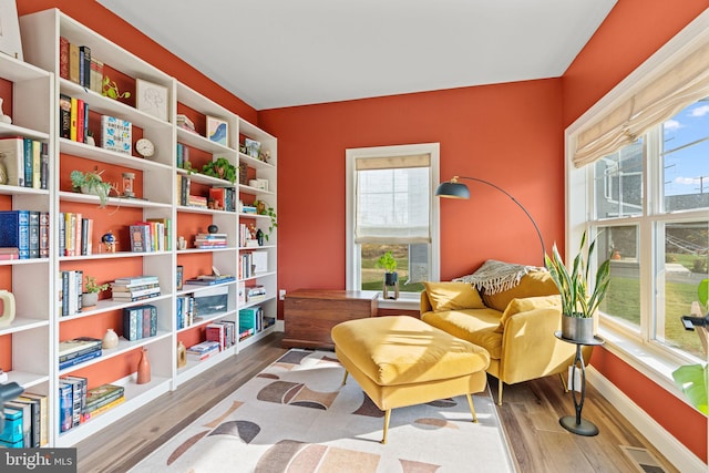 living area with hardwood / wood-style flooring and plenty of natural light