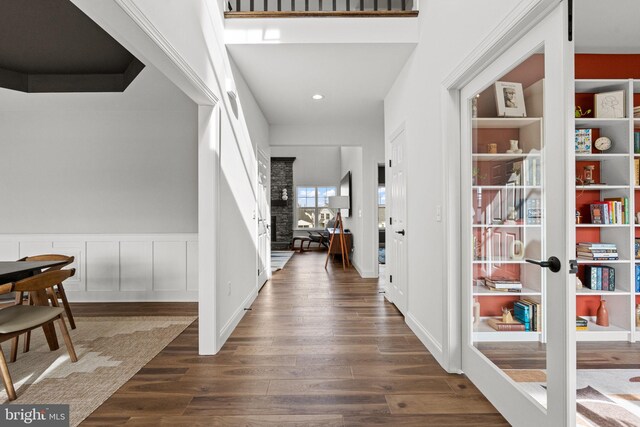 entryway with dark hardwood / wood-style flooring