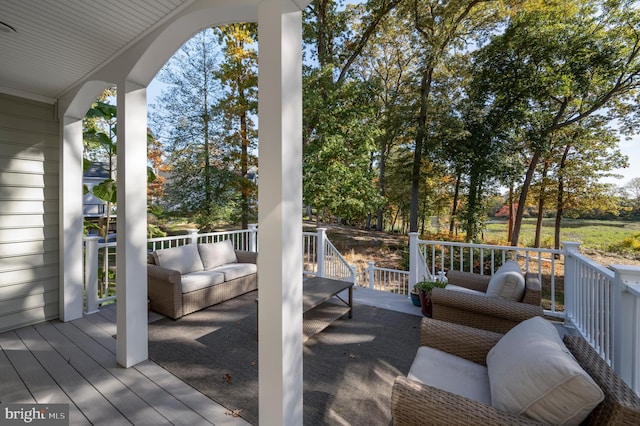 wooden deck with an outdoor living space