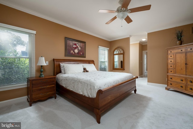 bedroom with light carpet, ornamental molding, and ceiling fan