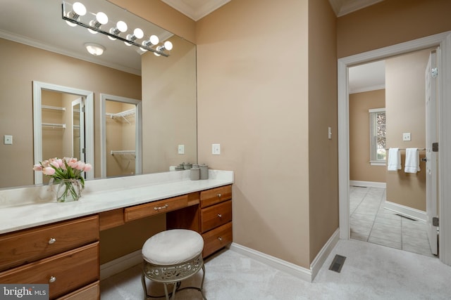 bathroom with vanity, crown molding, and tile patterned floors