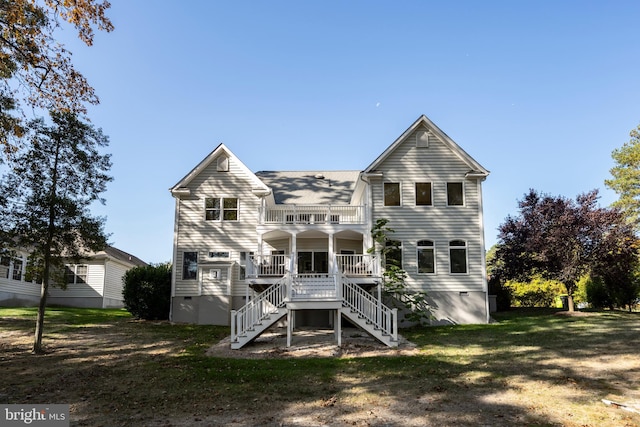 rear view of property featuring a yard and a porch