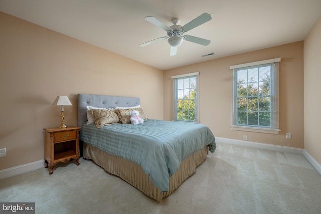 bedroom featuring light colored carpet and ceiling fan