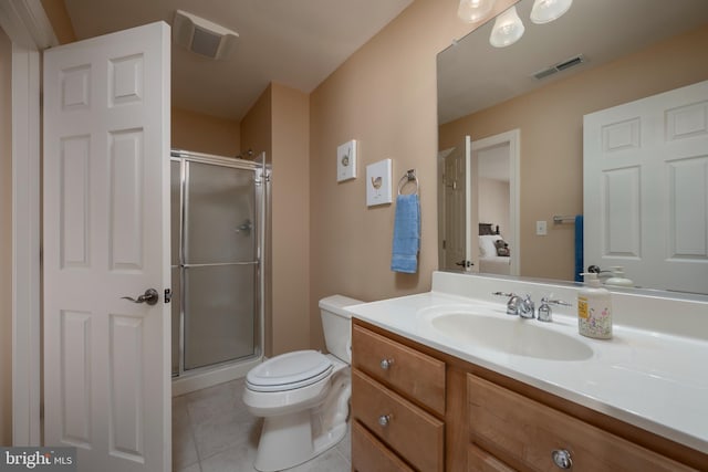 bathroom with vanity, toilet, tile patterned flooring, and an enclosed shower