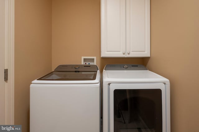 laundry area featuring cabinets and washing machine and dryer