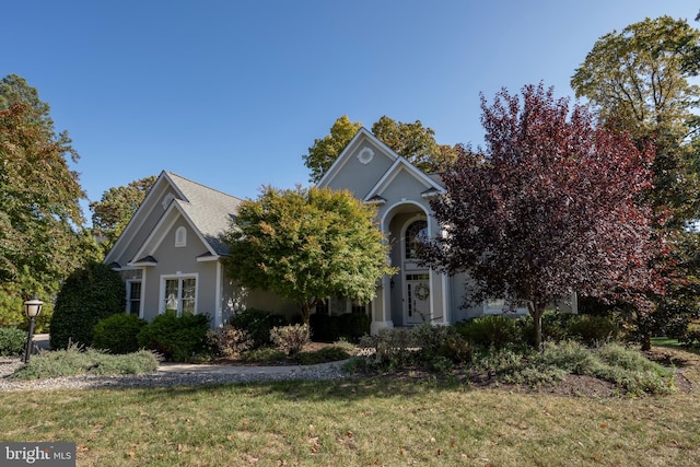 obstructed view of property with a front yard