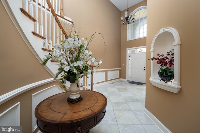 entryway with a chandelier and a high ceiling