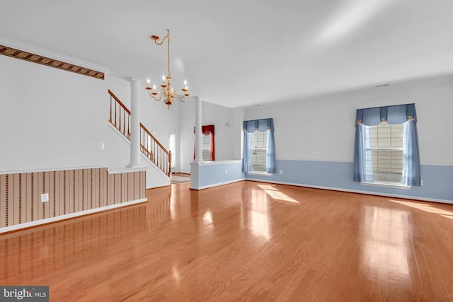 unfurnished living room featuring light hardwood / wood-style flooring and a chandelier