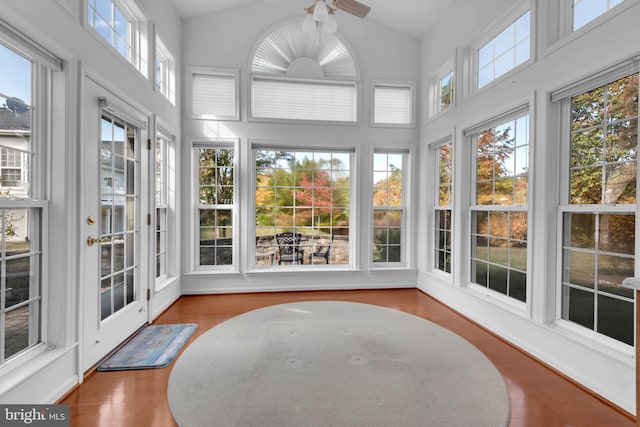 sunroom / solarium featuring lofted ceiling and ceiling fan