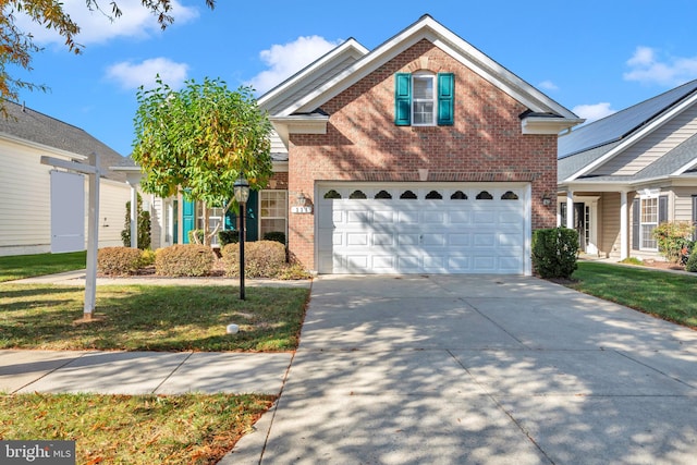 view of front property featuring a front yard and a garage