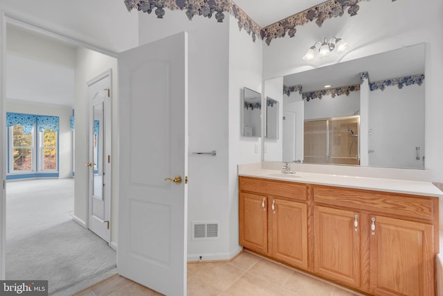 bathroom with vanity, walk in shower, and tile patterned flooring