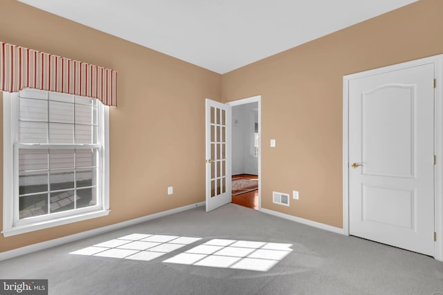 empty room featuring light colored carpet