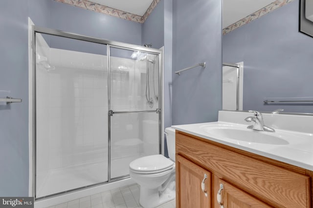 bathroom featuring vanity, toilet, tile patterned floors, and a shower with door