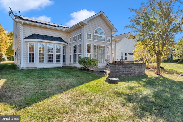 rear view of house with a lawn