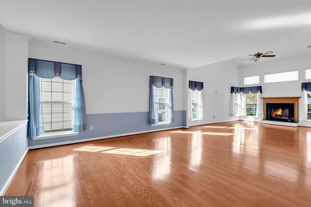 unfurnished living room featuring light hardwood / wood-style floors, a healthy amount of sunlight, and ceiling fan