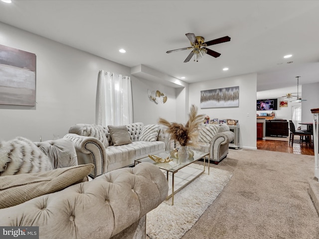 living room featuring dark hardwood / wood-style flooring and ceiling fan