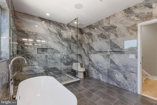 bathroom with tile walls, separate shower and tub, toilet, and tile patterned flooring