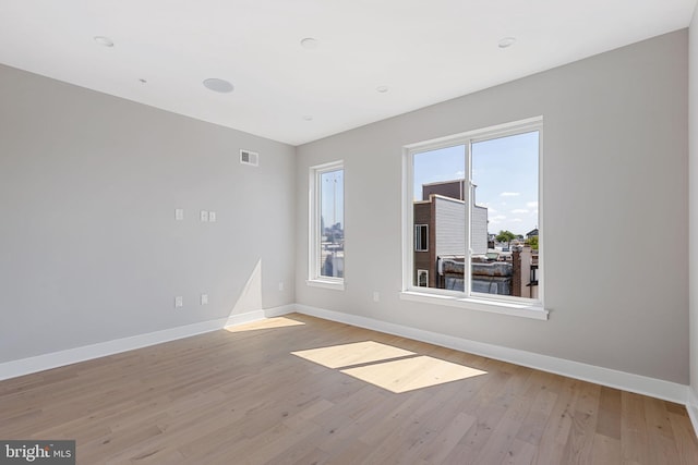 spare room with light hardwood / wood-style flooring