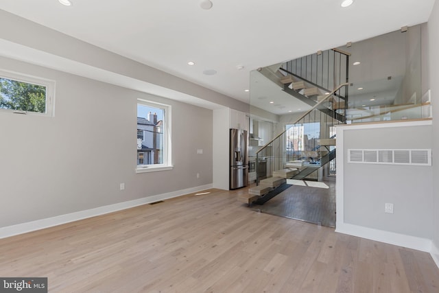 interior space with light hardwood / wood-style floors and plenty of natural light