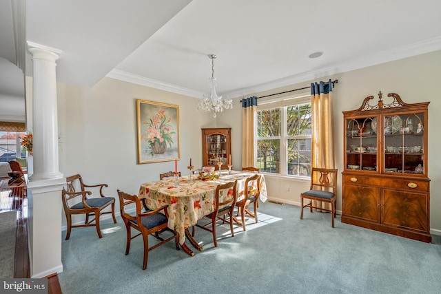 dining area with a notable chandelier, ornamental molding, ornate columns, and carpet floors