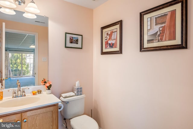 bathroom with toilet and vanity