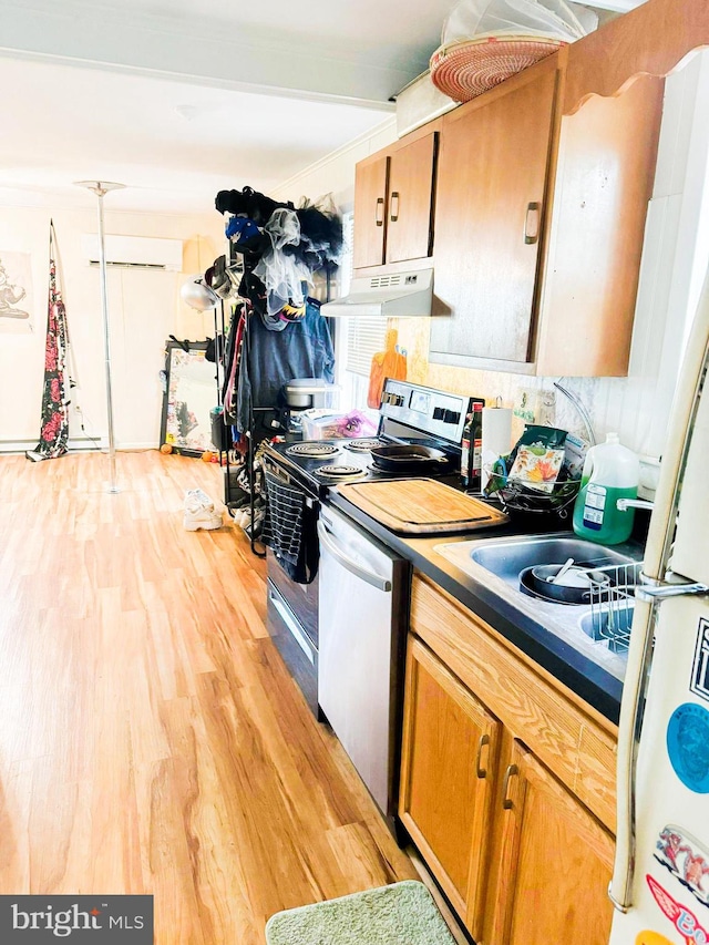 kitchen featuring stainless steel appliances and light hardwood / wood-style flooring