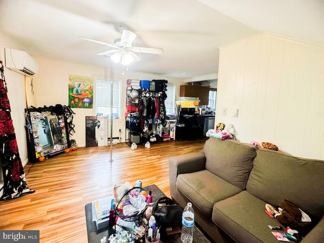 living room featuring ceiling fan, a wall unit AC, and wood-type flooring