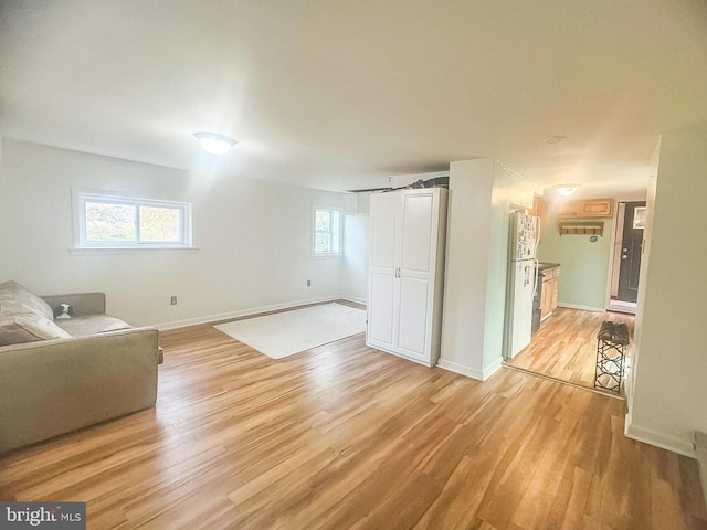 living room with plenty of natural light and light wood-type flooring