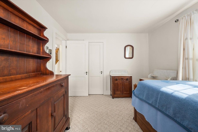 bedroom featuring light colored carpet