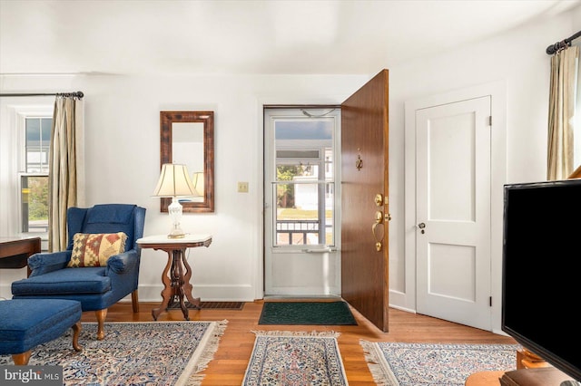 interior space featuring baseboards and light wood-style floors