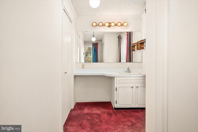 bathroom featuring vanity, a textured ceiling, and ornamental molding