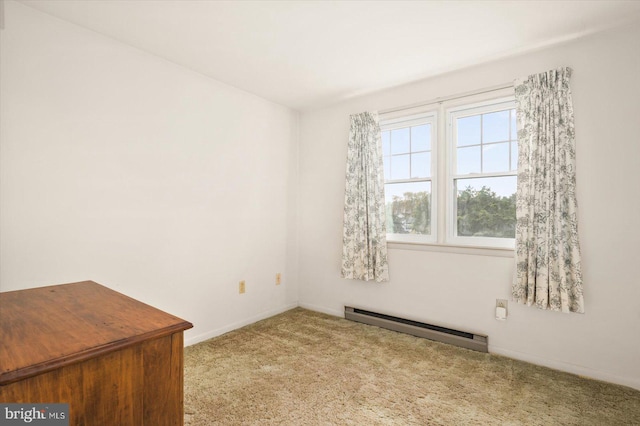 empty room with baseboard heating and light carpet