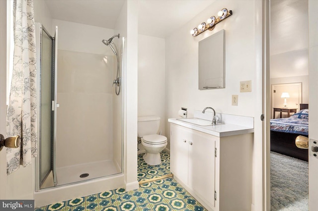 bathroom featuring vanity, toilet, and a shower with door