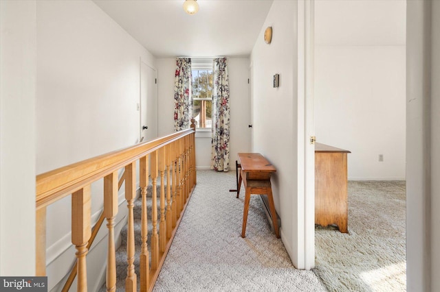 corridor with carpet flooring and baseboards