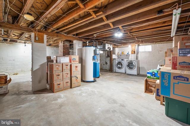 basement with water heater and washer and dryer