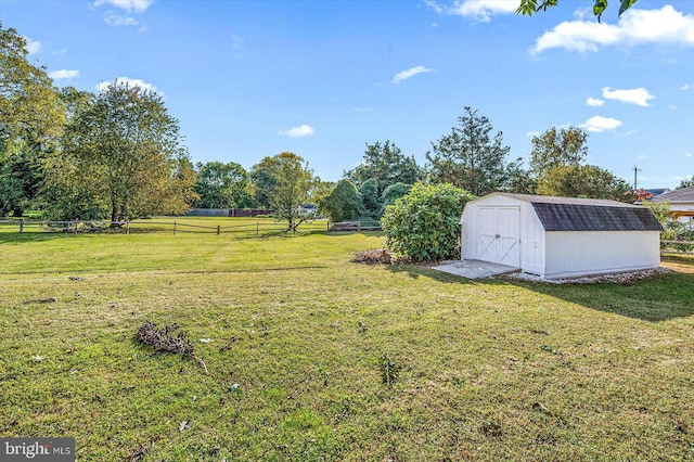 view of yard with a rural view and a shed