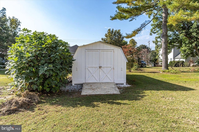 view of outbuilding with a yard