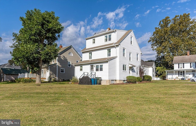 back of property featuring a yard