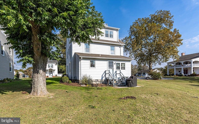back of house featuring a yard