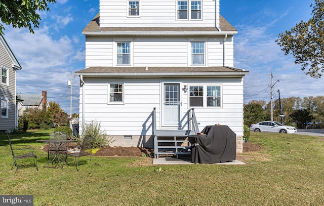 back of property featuring a yard, entry steps, crawl space, and a shingled roof