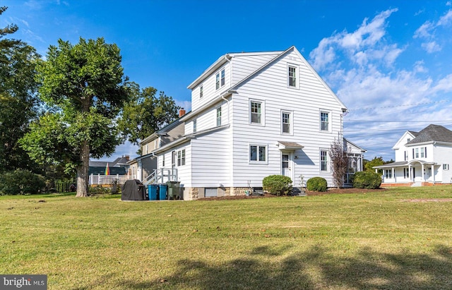 view of side of property with a yard