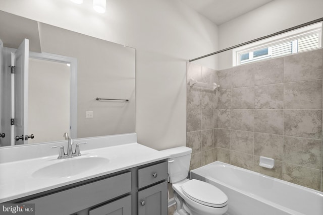 full bathroom with vanity, toilet, and tiled shower / bath combo