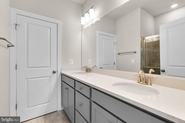 bathroom featuring vanity, tile patterned flooring, and a shower with door