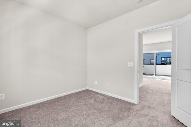 unfurnished room featuring light carpet