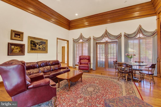 living room featuring light hardwood / wood-style flooring and crown molding