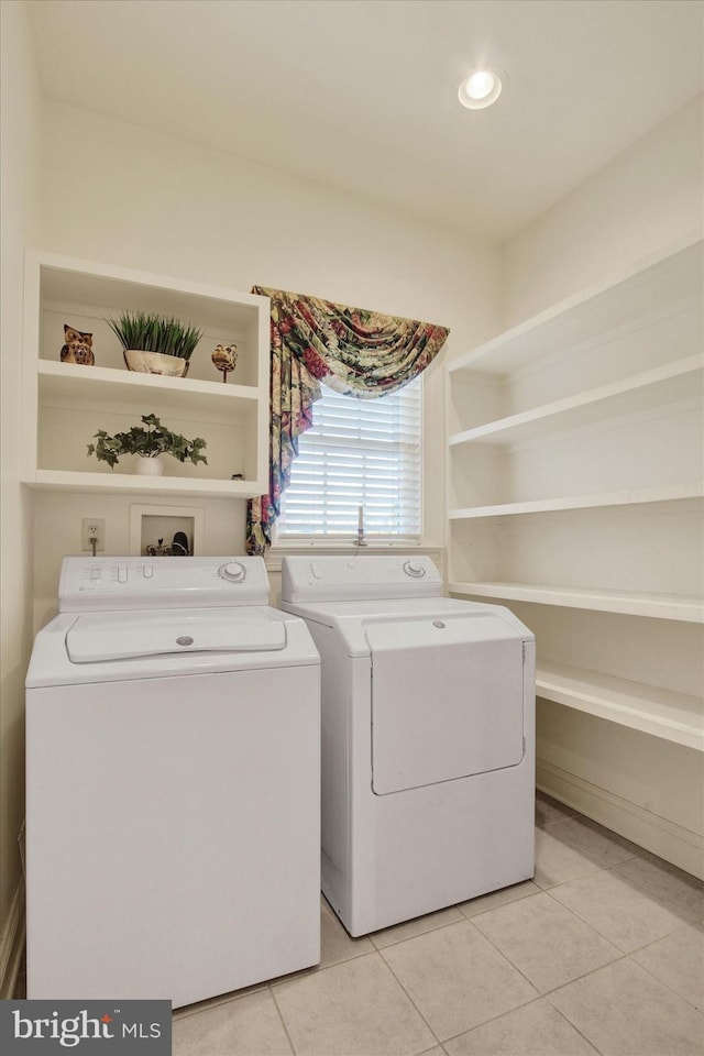 laundry room featuring washer and dryer and light tile patterned flooring