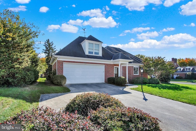 view of front of home featuring a front yard and a garage